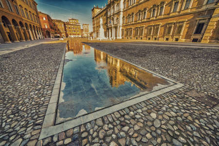 mirror of water of fountains in front of baroque Royal Palace in Modena, Italyの写真素材