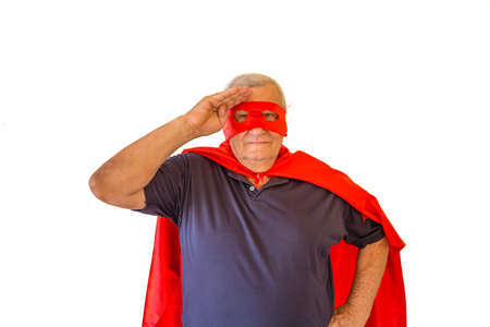 soldier saluting by old man wearing superhero costume with red cape and maskの写真素材