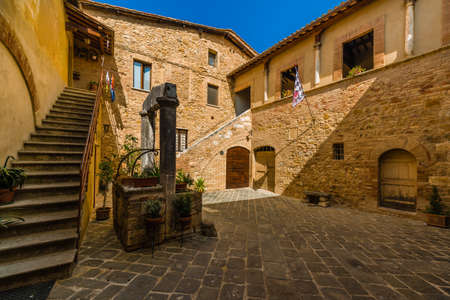 cobbled small square of undiscovered medieval village in Italy under the sun of Tuscanyの写真素材
