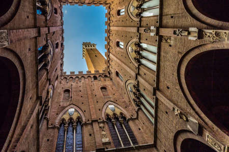 view of architectural wonders from public square of Siena, tuscan medieval town, Italyの写真素材