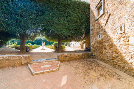 park on cobbled street of undiscovered medieval village in Italy under the sun of Tuscanyの写真素材