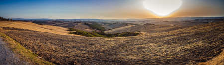sunset on cultivated fields in countryside near Siena, Italyの写真素材