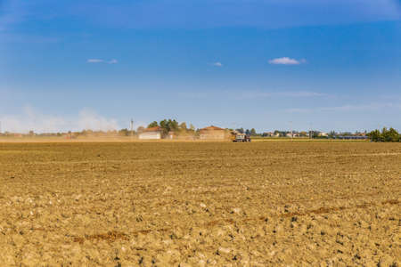 tractor running on cultivated fields in Italian countryside