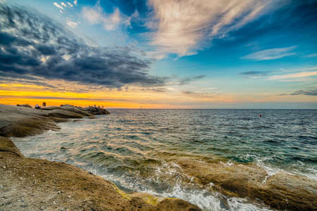 Scenic coastal sunset with orange light on island of Elbaの写真素材