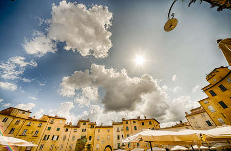 dizzy view of ancient buildings on the main square of Lucca, rare preserved wonder of medieval architecture in Italyの写真素材