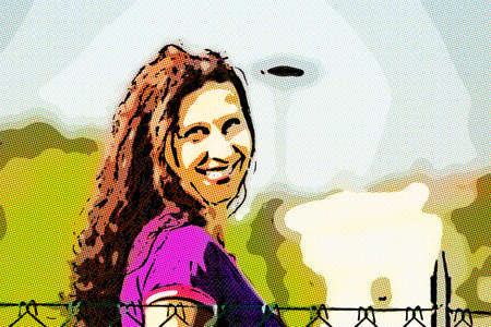 attractive woman wearing purple shirt smiles while walking