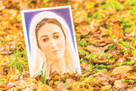 icon of the Blessed Virgin Mary on an autumnal carpet of leavesの写真素材