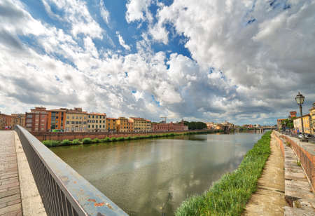 feelings of history in the ancient buildings along the river in Pisa under the sun of Tuscany, Italyの写真素材