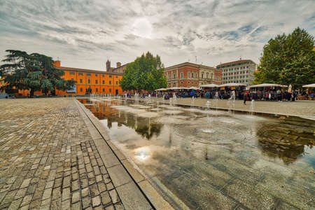 water games of XIX century fountain in front of weekly market in large square in Reggio Emilia