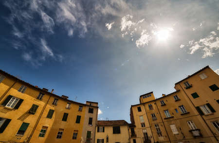 dizzy view of ancient buildings on the main square of Lucca, rare preserved wonder of medieval architecture in Italyの写真素材