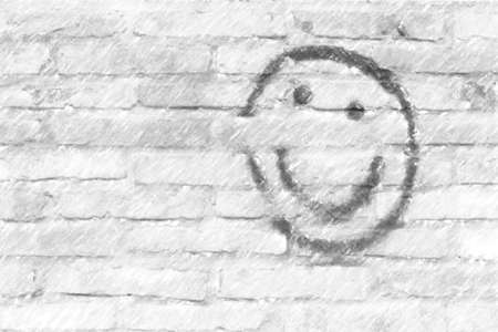 smiley face drawn on a brick wallの写真素材