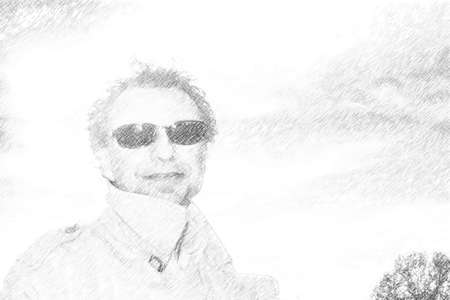 Handsome middle-aged man dressed in ocher gabardine is smiling with three-day beard, salt pepper hair and wearing a pair of black sunglasseの写真素材