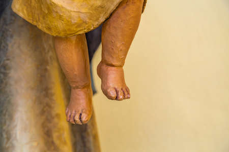 closeup of feet of statue of Baby Jesusの写真素材