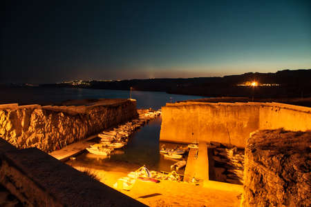 night view of ancient small marina in Puglia, Italyの写真素材