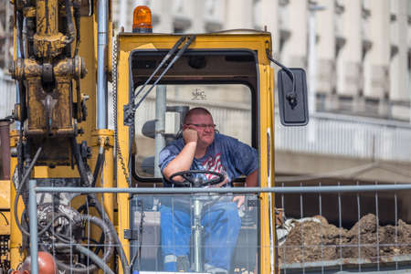 BUDAPEST, HUNGARY - SEPTEMBER 17, 2014: worker rests in the cabin of the crane. Thanks to...