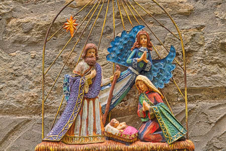 Christmas Nativity scene with The Holy Child, The Blessed Virgin Mary and Saint Joseph on grunge...
