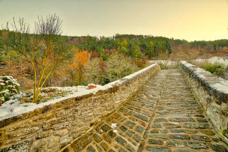 Ancient medieval donkey-back bridge with a unique arch in a village in the hills of Romagna in Italy...