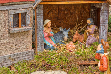 Christmas Nativity scene with The Holy Child, The Blessed Virgin Mary, Saint Joseph, ox and donkey