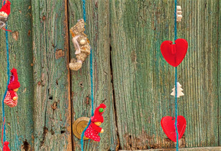 hanging hearts and Christmas decorations on old wooden doorの写真素材