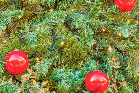 Christmas decorations background with red balls and green Plastic pine Needles