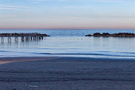 sunset on iron bridge for fishing boats on coast of the Adriatic Riviera on a cold winter day
