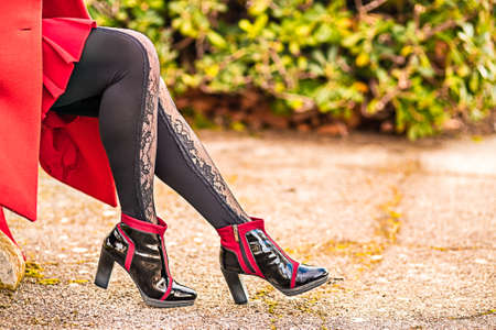 Closeup of sinuous and sensual legs with high-heeled ankle boots and sexy pantyhoseの写真素材