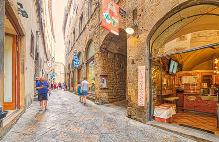 VOLTERRA, ITALY - AUGUST 31, 2017:  Tourists going shopping in the historic center of Volterraのeditorial素材