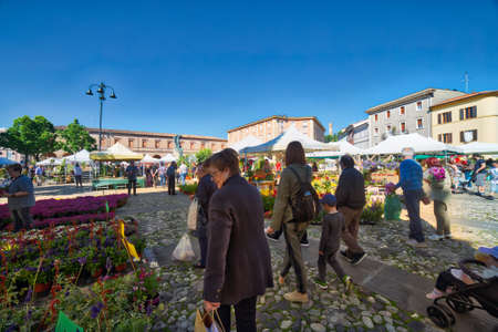 SANTARCANGELO DI ROMAGNA (FC), ITALY - MAY 14, 2017: tourists going shopping in Balconies in flowers, yearly Flower fair in medieval square of Santarcangeloのeditorial素材