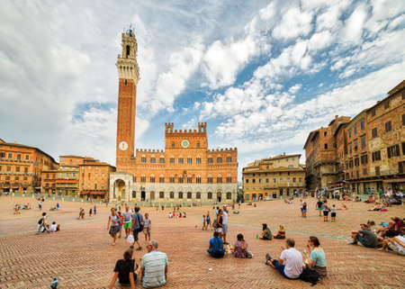 SIENA, ITALY - AUGUST 28, 2017: tourists walking in main square of Siena in Italy, where the famous horse race is heldのeditorial素材
