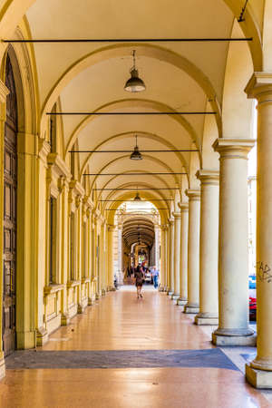 BOLOGNA, ITALY - AUGUST 27, 2016: on Saturday morning, few tourists and locals walk under the city porchesのeditorial素材