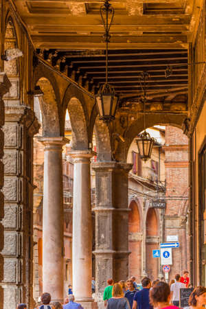 BOLOGNA, ITALY - AUGUST 8, 2016:  People come home walking under porches after summer hot working...