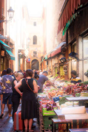 BOLOGNA, ITALY - AUGUST 27, 2016:  tourists and locals go shopping in medieval market. The trade vocation of this area known as Quadrilatero, meaning The Quadrilateral Area, was born in Middle Agesのeditorial素材