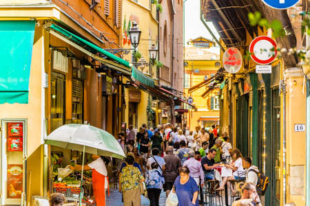BOLOGNA, ITALY - AUGUST 27, 2016:  tourists and locals go shopping in the medieval market. The trade vocation of this area known as Quadrilatero, meaning The Quadrilateral Area, was born in Middle Agesのeditorial素材