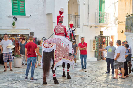 OSTUNI (BR) - AUGUST 28, 2016: Tourists and locals attend and enjoy the feast of the patron saint of the cityのeditorial素材