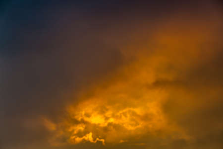 Background of cloudy orange sky at sunset