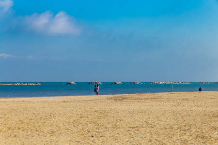 People walking on the beach in winterの写真素材