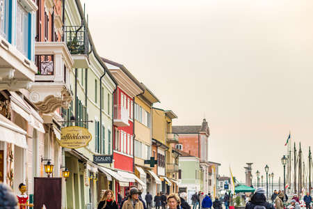 CESENATICO (FC) - FEBRUARY 10, 2018:  tourists walk along colorful houses in the street along the canal harbor of Cesenatico during winter seasonのeditorial素材