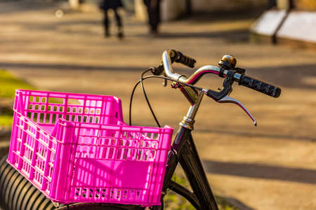 Old and rusty black bicycle with a fuchsia box for fruit as basketの写真素材