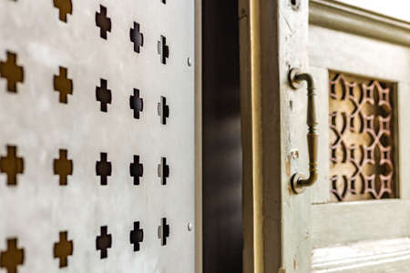Iron door punched with cross shaped holes