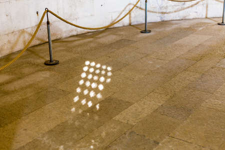 background of ancient stone floor with lit spots