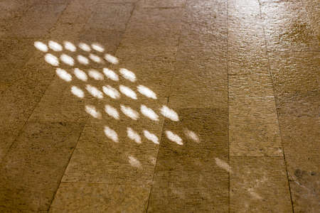 background of ancient stone floor with lit spotsの写真素材