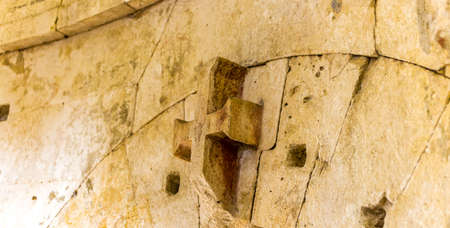 stone cross on arch of ancient wallの写真素材