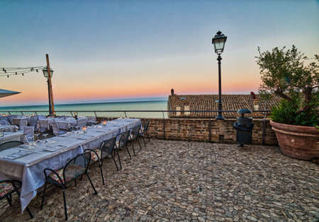 Italian Restaurant with sea view at sunsetの写真素材