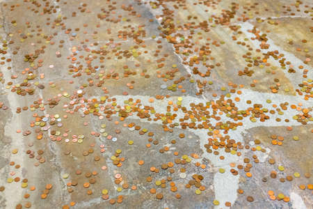 Coins thrown on ancient floor as a superstitious gesture to ask wishes or luckの写真素材