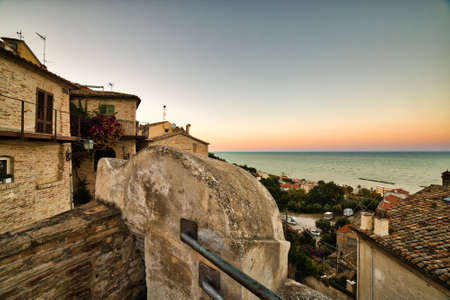 sunset on the roofs of picturesque village on the sea in Italyの写真素材