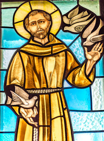 LUGO (RA) - FEBRUARY, 21 2018: Saint Francis welcoming birds in a stained glass in country churchのeditorial素材