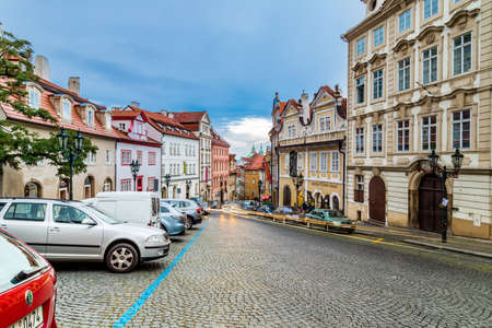 PRAGUE, CZECH REPUBLIC - AUGUST 26, 2014: locals and tourists walk and cars move in street in the historical center of Pragueのeditorial素材