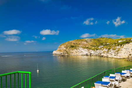 clear waters and green nature of bay on Ischia Island in Italyの写真素材