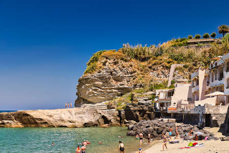 ISCHIA (NA), iTALY - SEPTEMBER 20, 2012: tourists sunbathing on beach of island of Ischia, Napoli in Italyのeditorial素材
