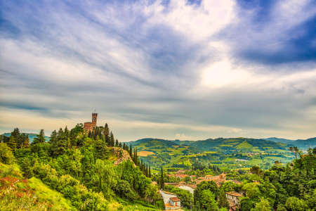 clock tower overlooking Italian village in green valleyの写真素材